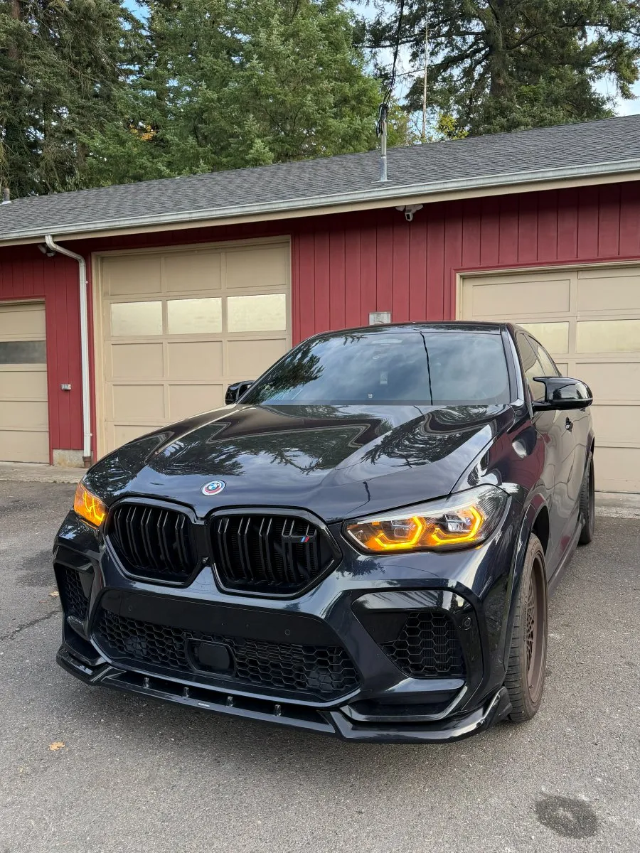 Black BMW F96 X6 M Competition after a performance midpipe install at PDXEuroWerks, a Portland BMW specialty shop in Oregon
