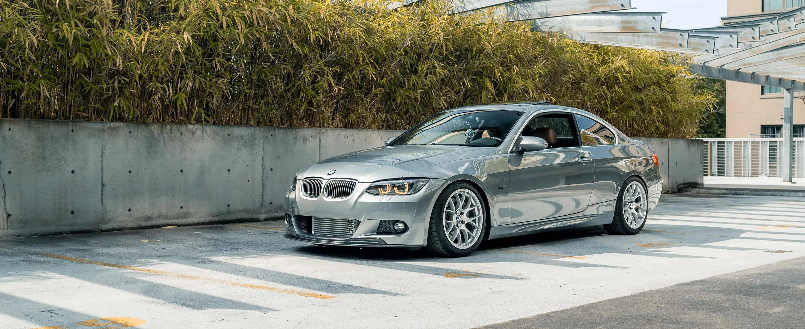 Space Grey BMW E92 335i on lightweight wheels with a front lip and catless downpipe setup, built by PDXEuroWerks in Portland, Oregon