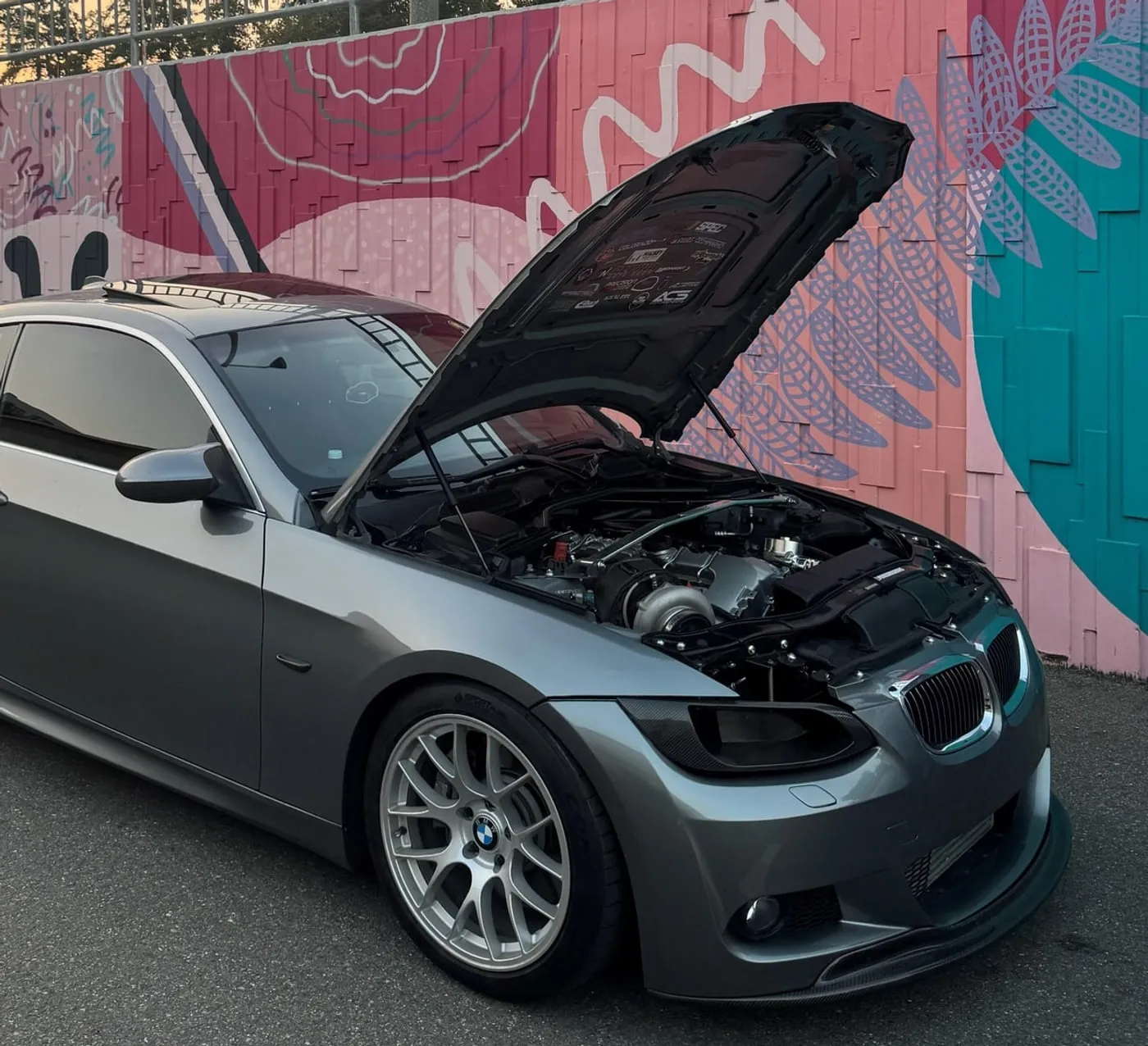 Single-turbo BMW E92 335i with the hood up showing the turbo and engine bay, built at PDXEuroWerks, a BMW performance shop in Portland, Oregon